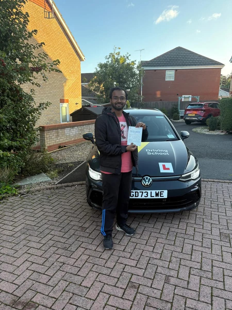 Akshet celebrating with his UK practical driving test pass certificate after manual lessons with Maurizio Gobbato at DrivePro Midlands