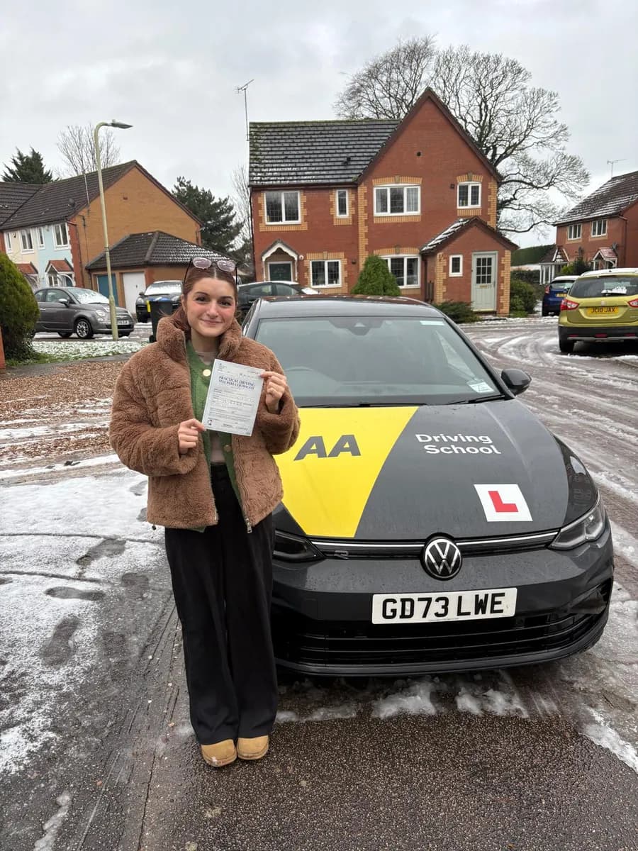Becky celebrating with her UK practical driving test pass certificate after manual lessons with Maurizio Gobbato at DrivePro Midlands