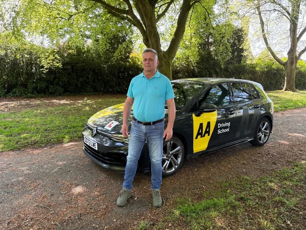 Maurizio Gobbato, DVSA-approved ADI (Approved Driving Instructor) at DrivePro Midlands, standing with the dual-control learner car in the East Midlands